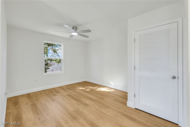 unfurnished bedroom with a closet, light hardwood / wood-style flooring, and ceiling fan