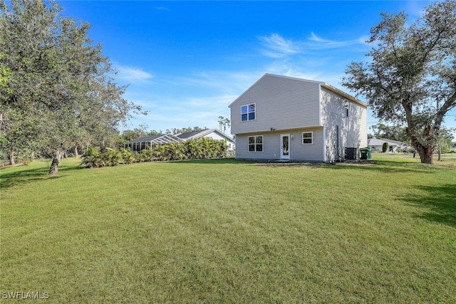 rear view of property featuring a yard