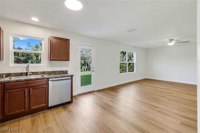 kitchen featuring stainless steel dishwasher, ceiling fan, light hardwood / wood-style floors, and sink