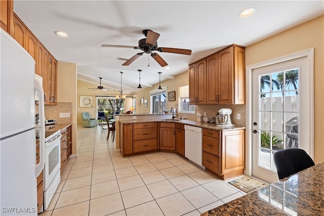 kitchen with tasteful backsplash, kitchen peninsula, pendant lighting, vaulted ceiling, and white appliances