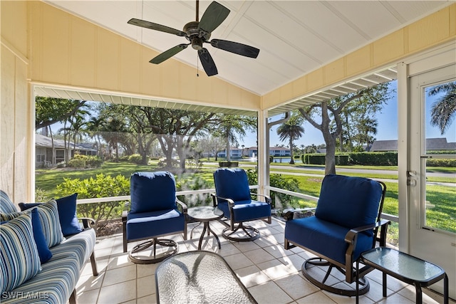 sunroom featuring ceiling fan and lofted ceiling