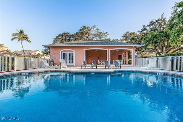 view of pool with ceiling fan, french doors, and a patio