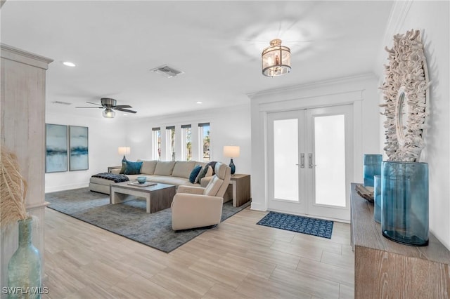 living room featuring crown molding, french doors, ceiling fan, and light hardwood / wood-style floors