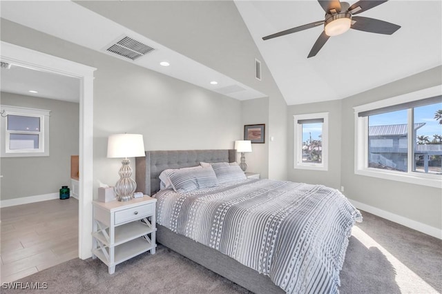 bedroom featuring light wood-type flooring, vaulted ceiling, and ceiling fan