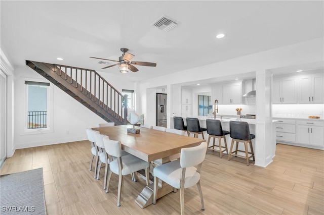 dining room featuring ceiling fan, light hardwood / wood-style flooring, and sink