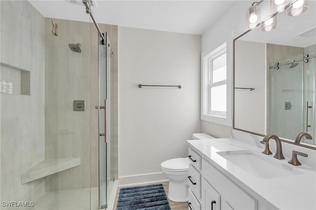 bathroom with a shower with door, vanity, wood-type flooring, and toilet