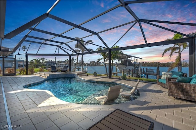 pool at dusk with a patio area, a lanai, a dock, and a water view