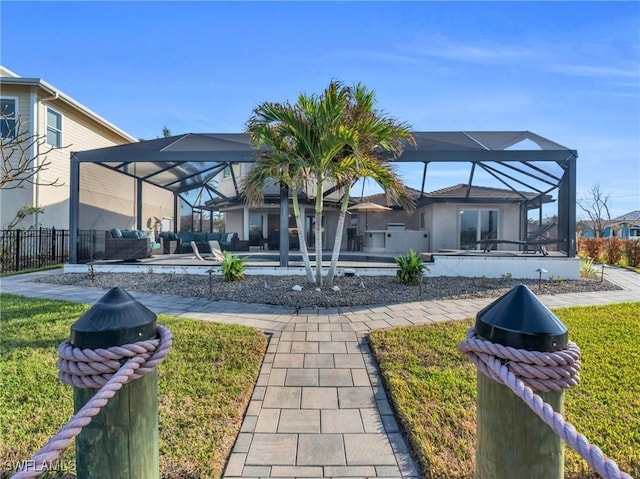 back of house with a lanai and a swimming pool