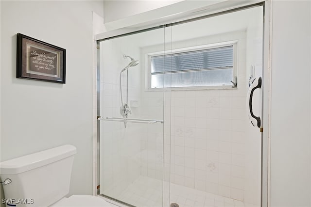 bathroom with an enclosed shower and toilet