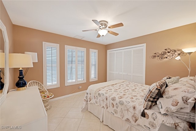 bedroom featuring a closet, ceiling fan, and light tile patterned flooring