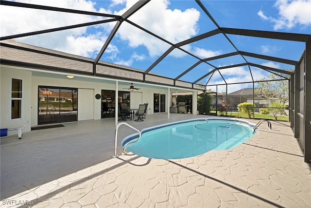 view of swimming pool featuring a patio area, ceiling fan, and a lanai