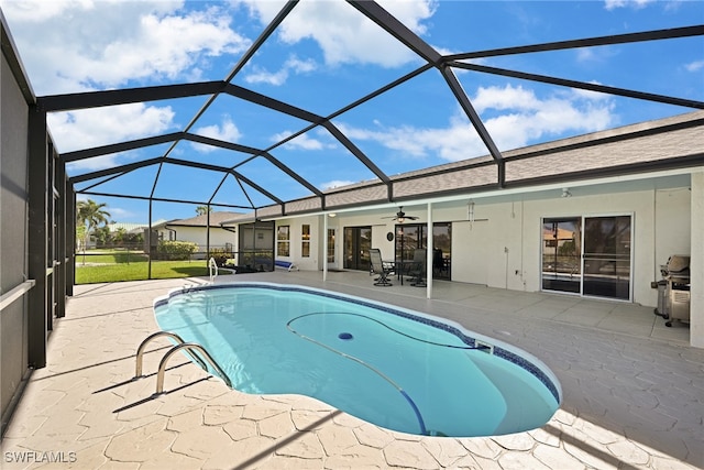 view of swimming pool featuring glass enclosure, ceiling fan, a patio area, and a grill