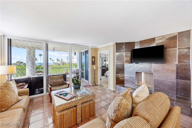 living room with a tile fireplace, crown molding, and tile walls