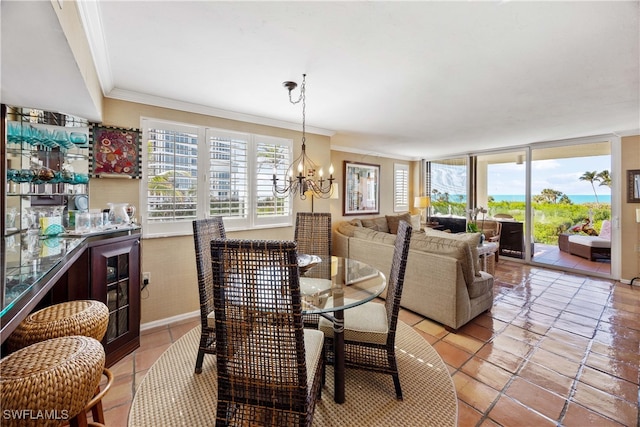 tiled dining space featuring a chandelier and crown molding