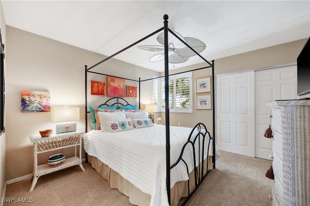 carpeted bedroom featuring ceiling fan and a closet