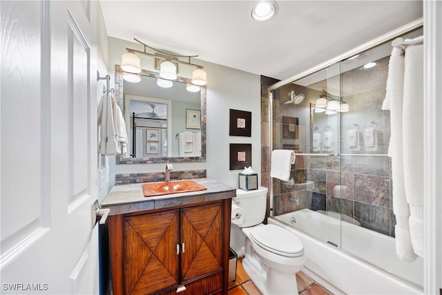 full bathroom with tile patterned flooring, vanity, toilet, and enclosed tub / shower combo