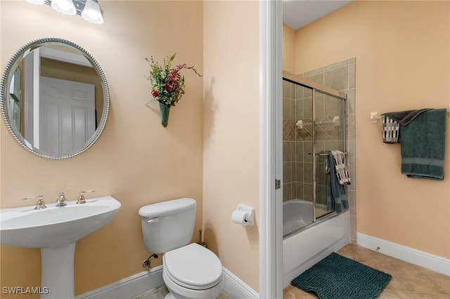 full bath with tile patterned floors, toilet, baseboards, and a sink