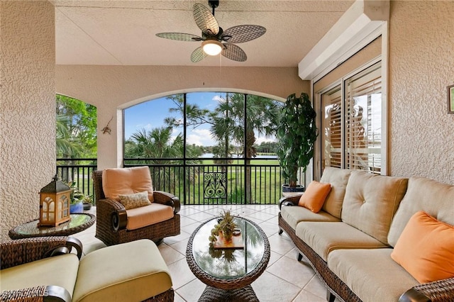 sunroom / solarium with a ceiling fan