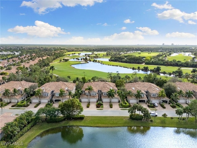 aerial view with a residential view, a water view, and golf course view