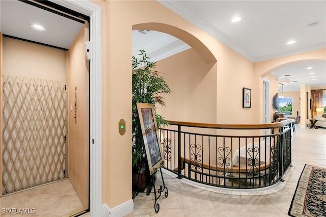 hallway with arched walkways, recessed lighting, baseboards, and ornamental molding