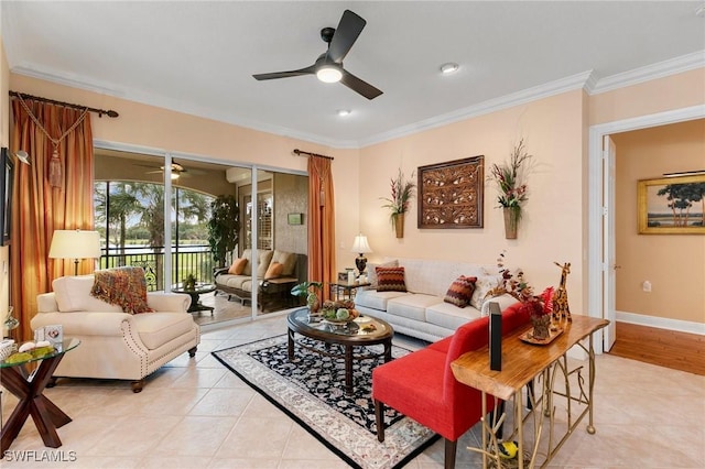 living area with light tile patterned floors, baseboards, ornamental molding, and a ceiling fan