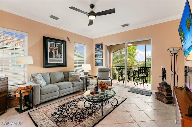 living area featuring light tile patterned floors, visible vents, crown molding, and ceiling fan