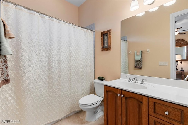 bathroom featuring vanity, tile patterned floors, and toilet