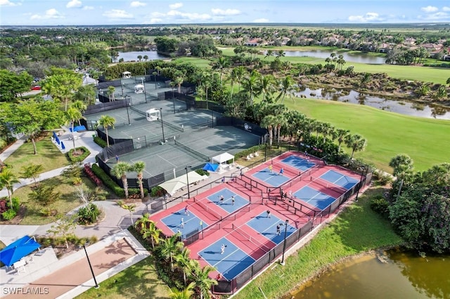 drone / aerial view with a water view and golf course view