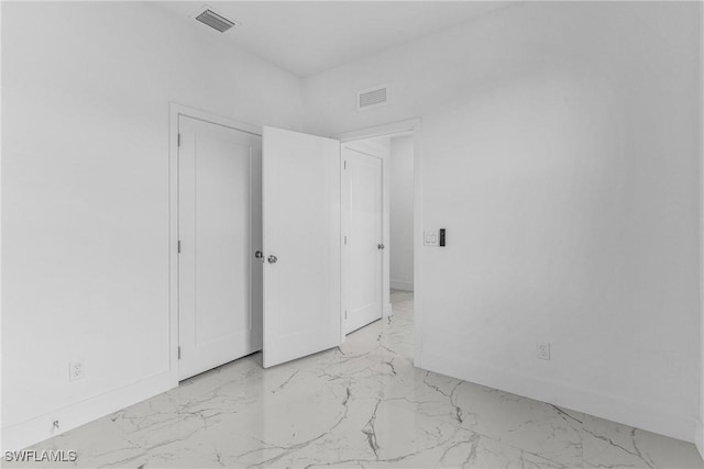 7014 Alfa Cir, Labelle, FL 33935 - unfurnished bedroom with light marble finish floors and baseboards