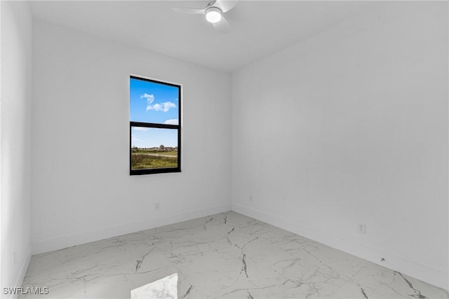 7014 Alfa Cir, Labelle, FL 33935 - spare room featuring baseboards, marble look tile flooring, and ceiling fan