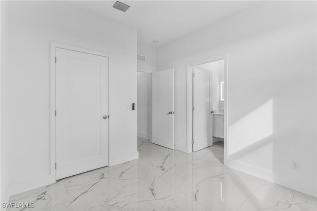 7014 Alfa Cir, Labelle, FL 33935 - unfurnished bedroom with light marble finish flooring, baseboards, and connected bathroom