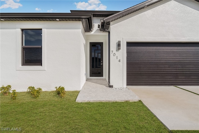 entrance to property with a yard and a garage