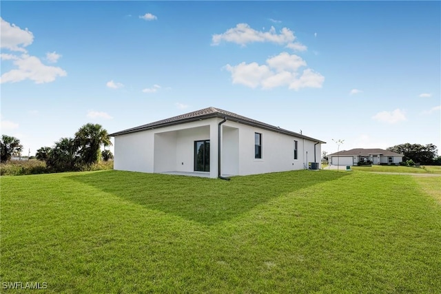 7014 Alfa Cir, Labelle, FL 33935 - rear view of house with a yard, stucco siding, and cooling unit