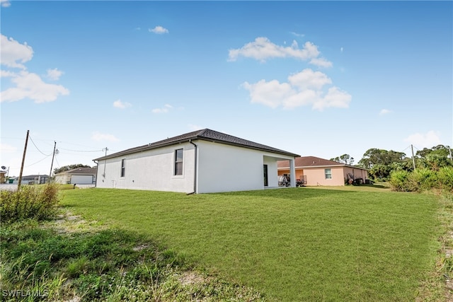 view of side of home with a lawn