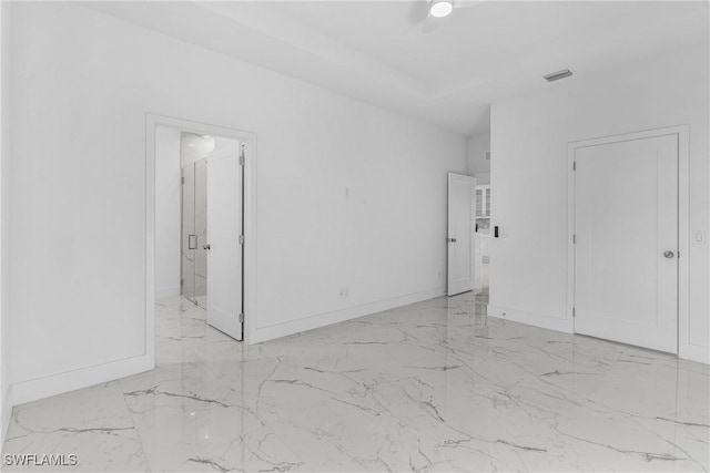 7014 Alfa Cir, Labelle, FL 33935 - unfurnished bedroom with marble tiled floors, baseboards, and ensuite bath