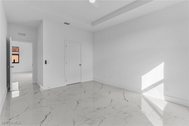 7014 Alfa Cir, Labelle, FL 33935 - unfurnished bedroom with light marble finish flooring, baseboards, and a ceiling fan