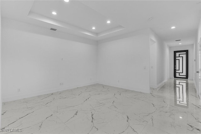 7014 Alfa Cir, Labelle, FL 33935 - spare room featuring recessed lighting, baseboards, and a tray ceiling