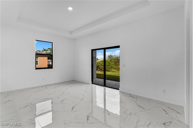 7014 Alfa Cir, Labelle, FL 33935 - unfurnished room with a tray ceiling, marble tiled floors, baseboards, and recessed lighting