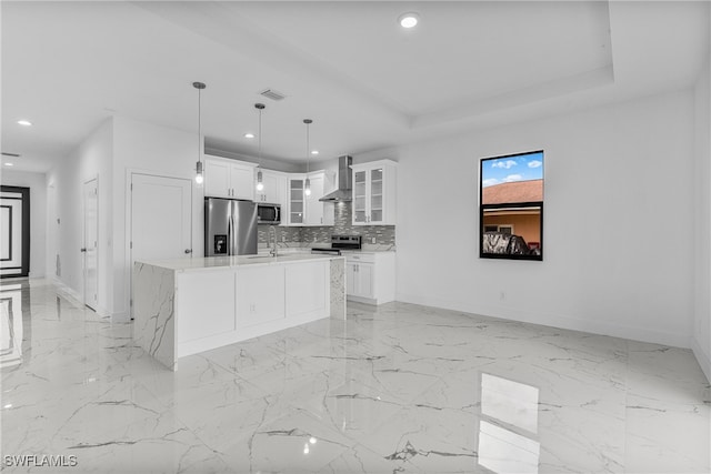 kitchen with white cabinetry, sink, hanging light fixtures, a center island with sink, and appliances with stainless steel finishes