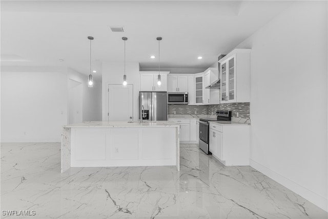 kitchen featuring white cabinets, a kitchen island, hanging light fixtures, and appliances with stainless steel finishes