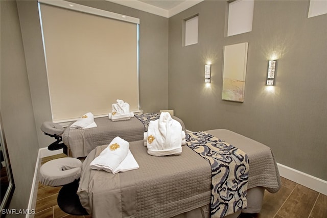 bedroom featuring dark hardwood / wood-style floors and ornamental molding