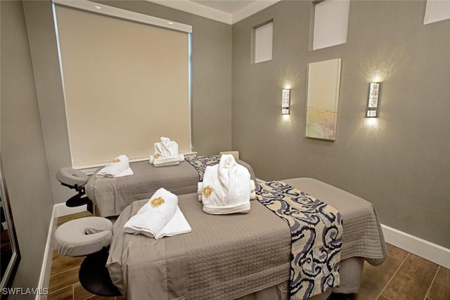 bedroom featuring wood tiled floor and baseboards