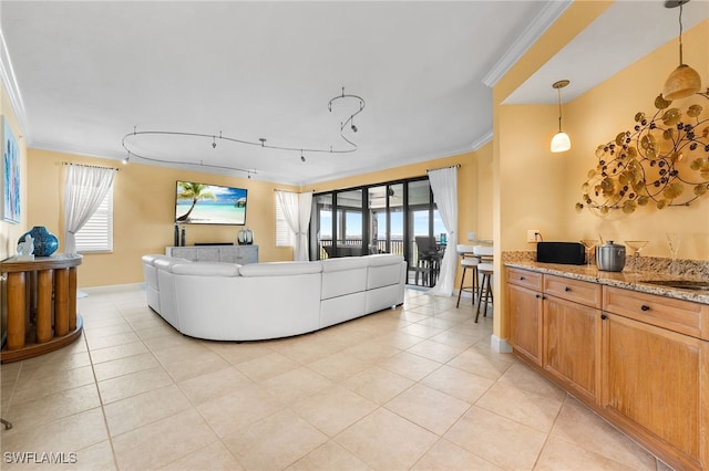 living room with a healthy amount of sunlight, light tile patterned floors, and crown molding