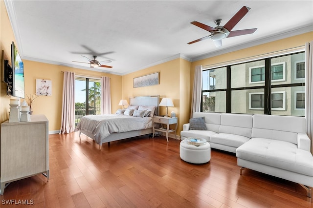 bedroom featuring ceiling fan, hardwood / wood-style floors, and ornamental molding