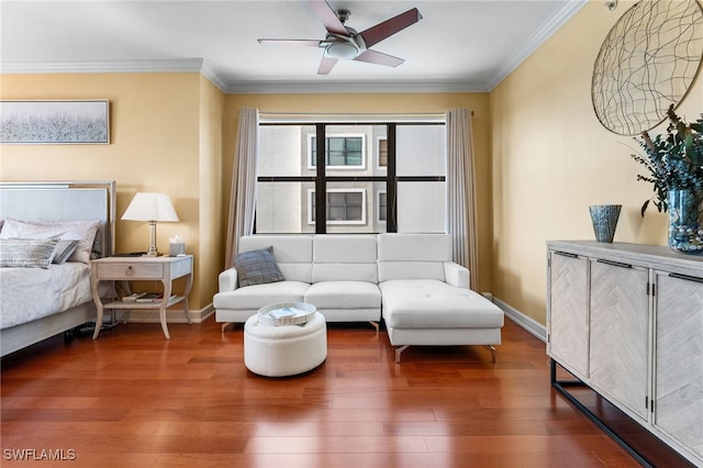 interior space featuring ceiling fan, wood-type flooring, and crown molding