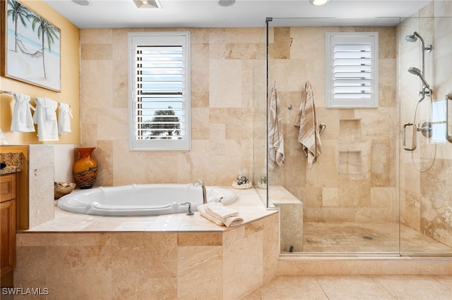 bathroom featuring separate shower and tub, a wealth of natural light, and tile walls