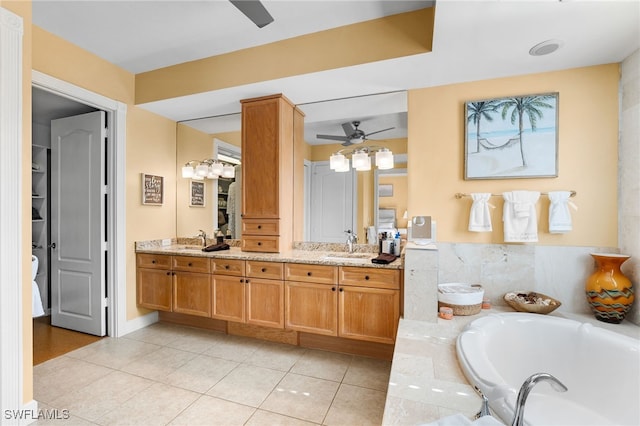 full bathroom with double vanity, ceiling fan, tile patterned floors, a sink, and a bath