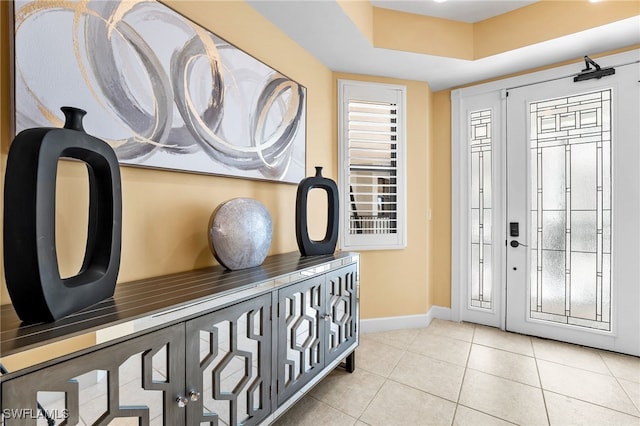 entrance foyer featuring light tile patterned floors and baseboards