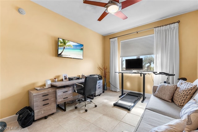 office area featuring a ceiling fan, baseboards, and light tile patterned floors