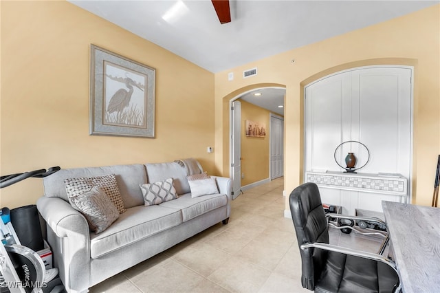 office space featuring arched walkways, visible vents, baseboards, and light tile patterned floors